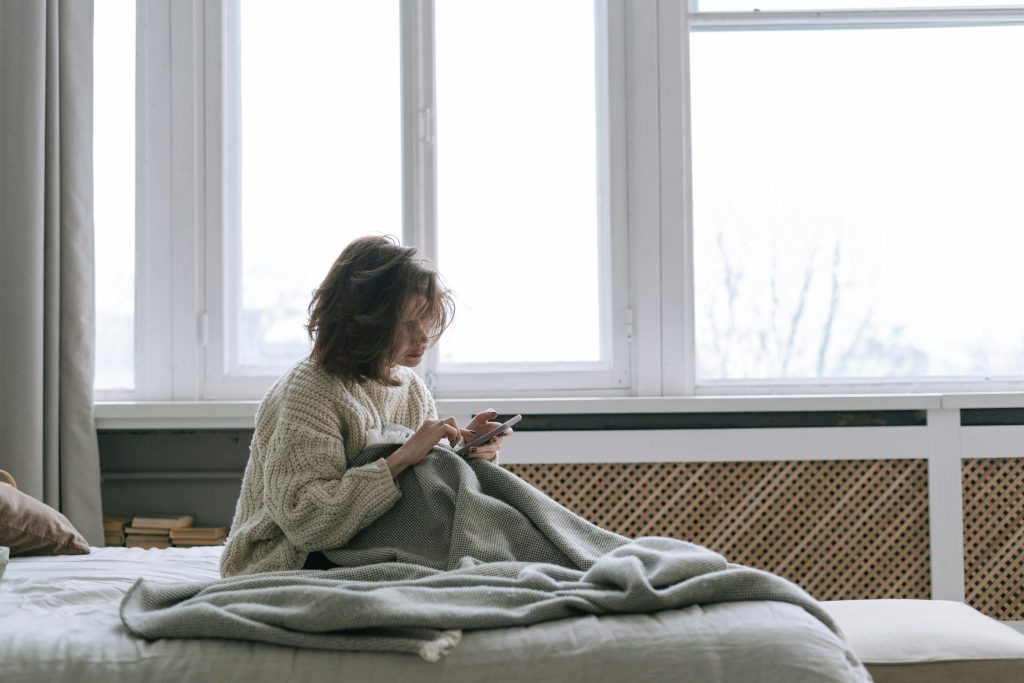 Woman in comfort zone on bed